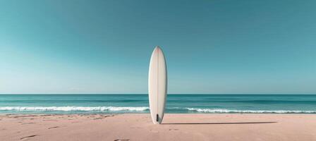 White Surfboard Standing on Sandy Beach With Calm Ocean Water and Blue Sky photo