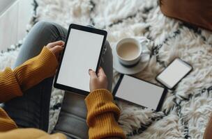 Woman Using Tablet While Sitting on a Fluffy Rug photo