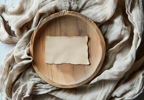 Blank White Card on Wooden Plate With Beige Fabric and Dried Flowers photo