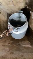 vertical Bucket on a chain for extracting water from a well. video