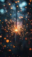 Sparkler glowing brightly during nighttime celebration with colorful bokeh lights in background photo