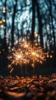 Sparkler glowing brightly during nighttime celebration with colorful bokeh lights in background photo