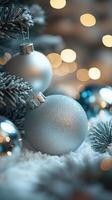 Decorative silver baubles on a Christmas tree with blurred lights in the background photo