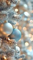 Decorative silver baubles on a Christmas tree with blurred lights in the background photo