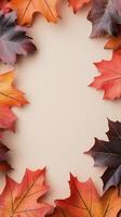 Autumn leaves arranged on a light background create a natural frame for seasonal decoration photo