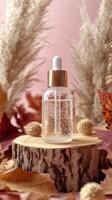 Clear serum bottle on a wooden slice surrounded by autumn foliage in a cozy setting photo