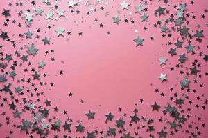 Decorative silver stars arranged in a circular pattern on a pink background for festive celebrations photo