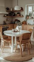 Cozy kitchen dining setup with wooden cabinets and round table near window in a sunlit room photo