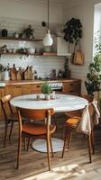 Cozy kitchen dining setup with wooden cabinets and round table near window in a sunlit room photo
