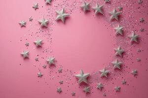 Decorative silver stars arranged in a circular pattern on a pink background for festive celebrations photo