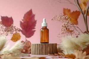 Serum bottle placed on wooden stump surrounded by dried flowers and leaves in soft light photo
