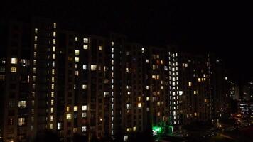 Night city. Multistorey residential building. The windows of the house glow in the dark. video