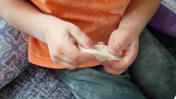 A little boy learns to make dumplings in the kitchen video