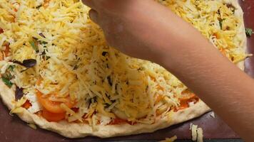 Hand Adding Grated Cheese to a Homemade Pizza video