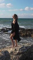Woman Beach Coastline Standing Rocky Shore Looking Up at Sky video