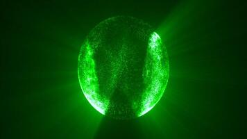 A green luminous orb sphere floating in darkness, dotted with light specks and radiating mystical energy, like a futuristic vision or sci-fi representation video