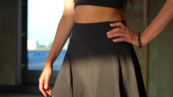 Girl in Black Confidently Walks Toward Gym Window in Close-Up, Camera Moves video