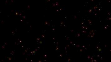 Animation yellow, pink firefly particles glowing sparkles on dark background. video