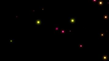 Animation yellow, pink firefly particles glowing sparkles on dark background. video