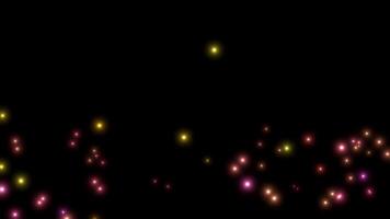 Animation yellow, pink firefly particles glowing sparkles on dark background. video