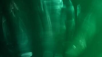 A green background with blurry lines and shapes video