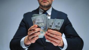 Formally dressed man is counting US Dollar bills, close-up. video