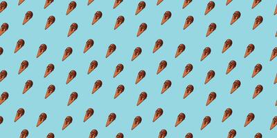a seamless pattern with brown chocolate ice cream on a blue background vector