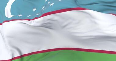 Flag of Uzbekistan waving at wind in slow with blue sky, loop video