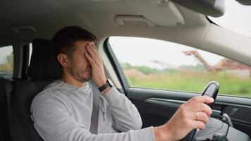 Tired man falling asleep while driving car on highway road. Sleepy male driver closes his eyes and lose concentration. Dangerous driving video