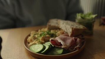Delicious sandwiches with eggs, ham and cucumbers served on buffet table for brunch video