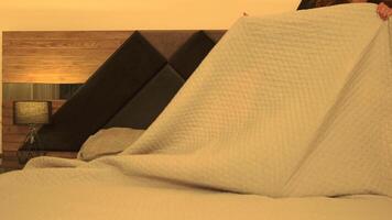 Woman Walks Toward Bed and Lies Down for Rest in a Peaceful, Evening Setting video