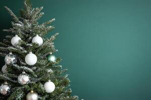 Beautifully decorated Christmas tree with silver ornaments against a dark green background photo