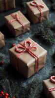 Beautifully wrapped holiday gifts arranged with pinecones and candy canes on a dark background photo