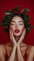 Young woman with festive wreath posing cheerfully against a vibrant red background in winter photo