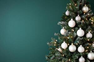 Beautifully decorated Christmas tree with silver ornaments against a dark green background photo