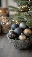 Elegant black and gold Christmas ornaments in a woven basket near a festive tree photo