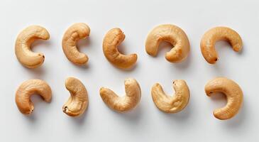 Twelve Whole Cashew Nuts on a White Background photo