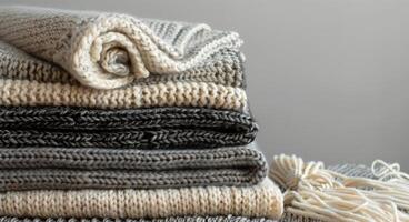Stack of Knit Blankets With Fringes on a Couch photo