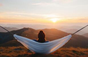 Woman Relaxing in Hammock at Sunset photo