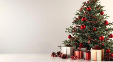 Decorated Christmas Tree With Gifts in Front of a White Wall photo