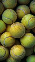 Pile of Tennis Balls on Table photo