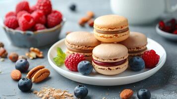 Colorful Macarons With Fresh Berries and Pecans on a Plate photo