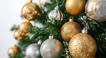Close Up of Gold and Silver Ornaments Hanging on a Christmas Tree photo