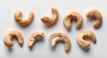 Twelve Whole Cashew Nuts on a White Background photo