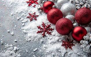 Festive Red Ornaments and Snow-Covered Pine Branches on a White Background photo