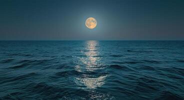 Full Moon Shining on a Calm Ocean at Night photo