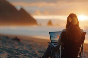 Woman Working on Laptop at Sunset Beach photo