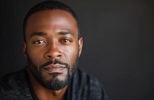 Close Up Portrait of a Young Man With Short Hair and a Goatee photo