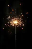 Sparkler illuminating darkness with bright flames and glowing sparks during a celebration photo