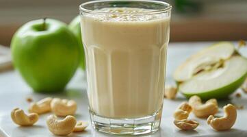 Creamy Apple Cashew Smoothie With Green Apples on a Wooden Table photo